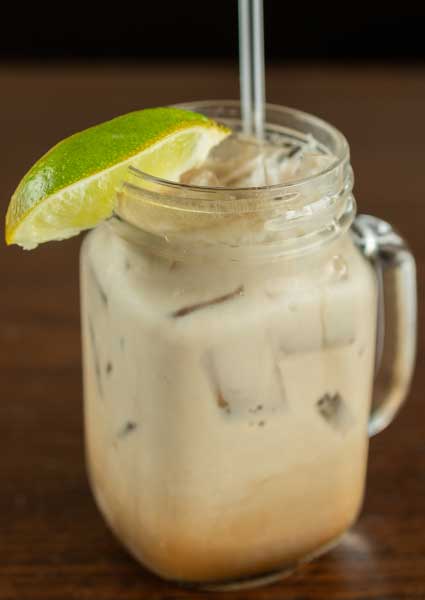Iced creamy drink in a mason jar, served at our restaurant in Monticello MN with a lime wedge.