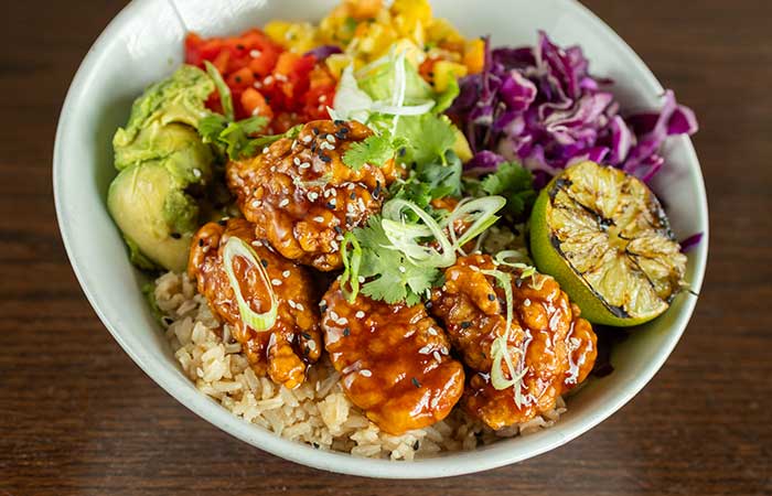 Featured on our restaurant menu Monticello MN: rice bowl with saucy chicken, avocado, and more.