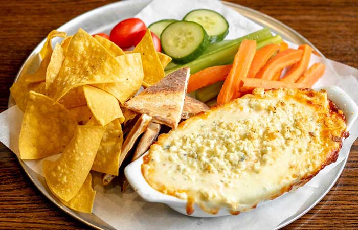 Find this cheesy dip and fresh veggies combo on our restaurant menu in Monticello, MN today!.