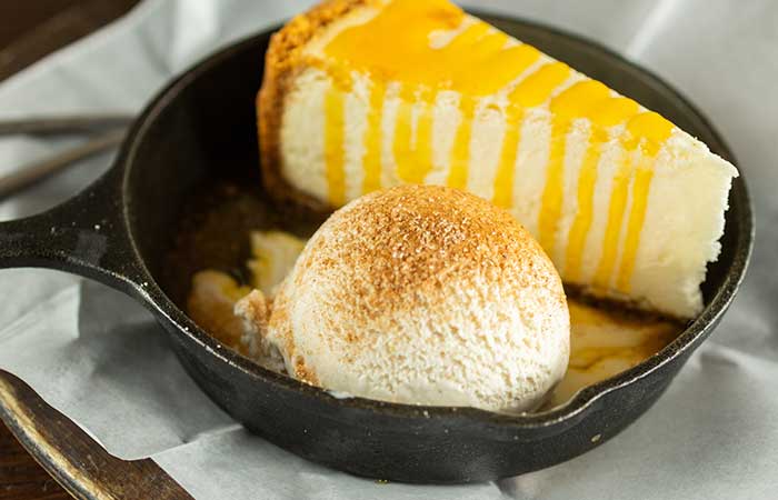 Featured on our restaurant menu in Monticello, MN: cheesecake with yellow sauce and ice cream.