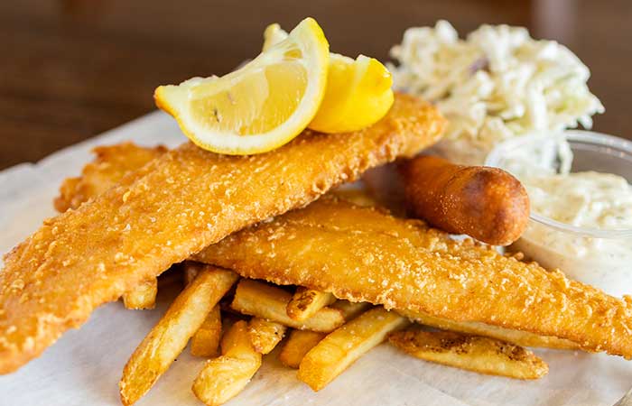 Featured on our restaurant menu in Monticello MN: fried fish, coleslaw, fries, sauce, hush puppy.