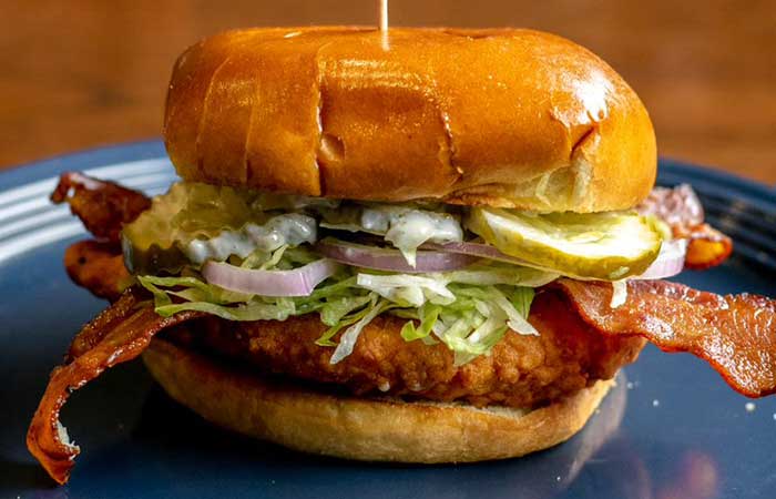 A restaurant menu favorite in Monticello MN: crispy chicken sandwich with bacon and fixings.