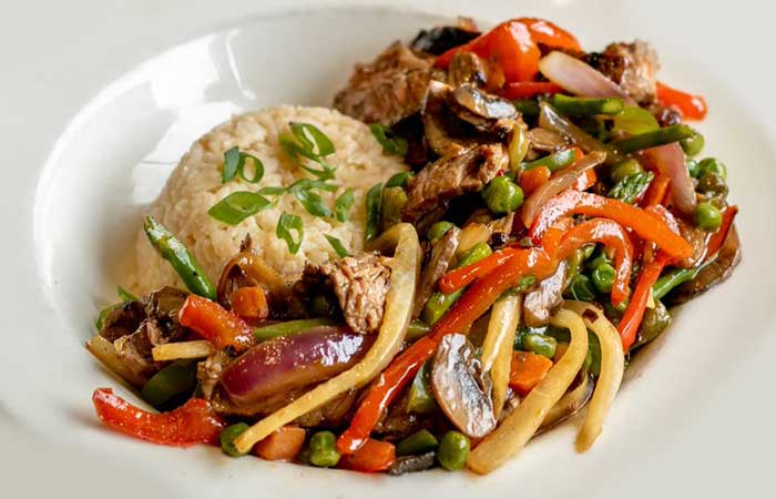 A restaurant menu favorite in Monticello MN: stir-fried beef, veggies, rice, and green onions.