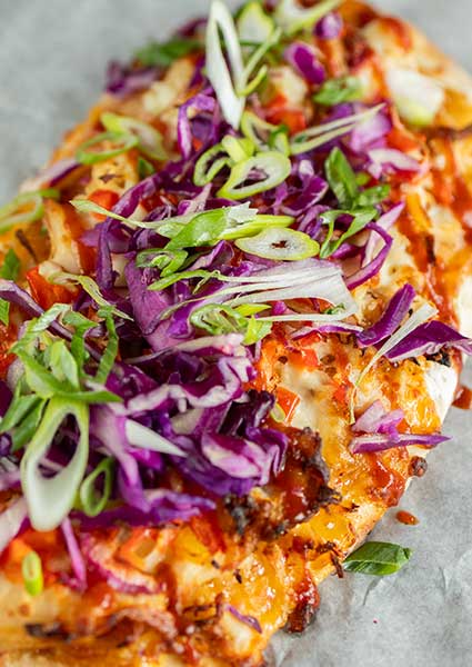Flatbread pizza from a restaurant in Monticello MN, topped with red cabbage and green onions.