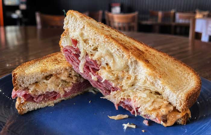 A Reuben sandwich from our restaurant in Monticello MN, served on toasted rye and cut in half.