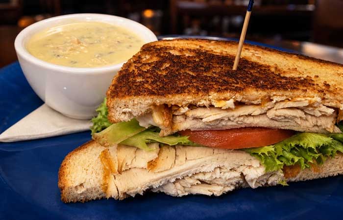 Enjoy lunch in Monticello MN—a grilled chicken sandwich with lettuce, tomato, and creamy soup.