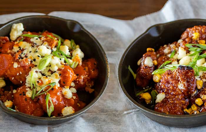 Enjoy these saucy fried chicken bites at happy hour in Monticello MN—cheesy, crisp, and tasty!.