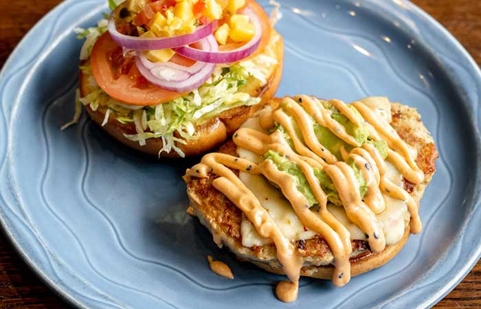 A restaurant menu favorite in Monticello MN: open-faced chicken sandwich with fresh toppings.